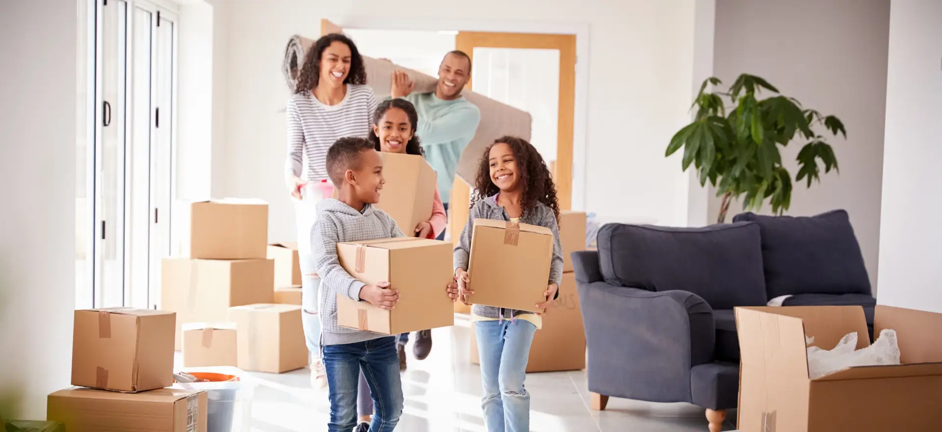 Happy family moving in to their new home thanks to AskALoanOfficer.com